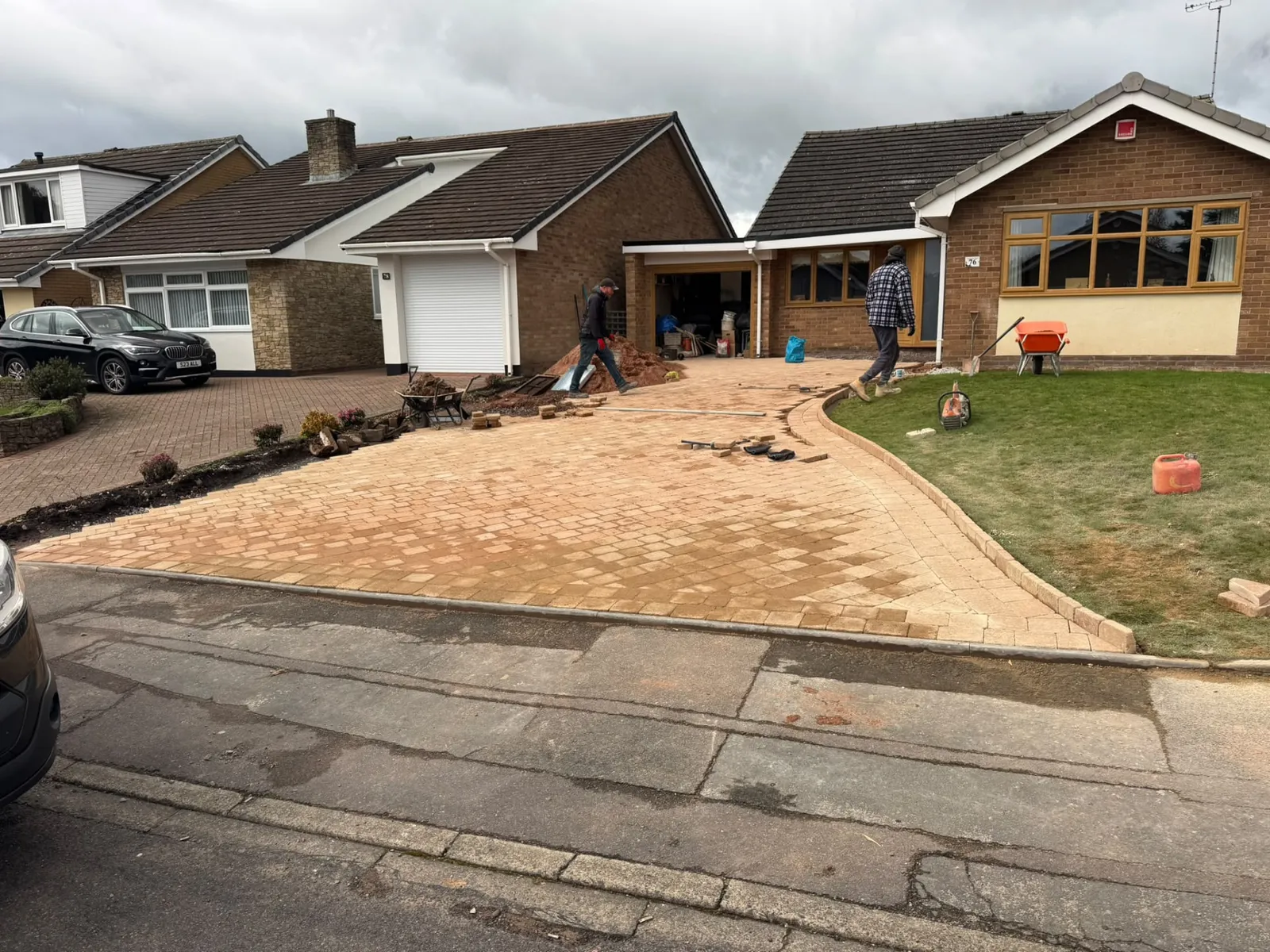 Block paving driveway under construction with compacted sub-base and edging laid