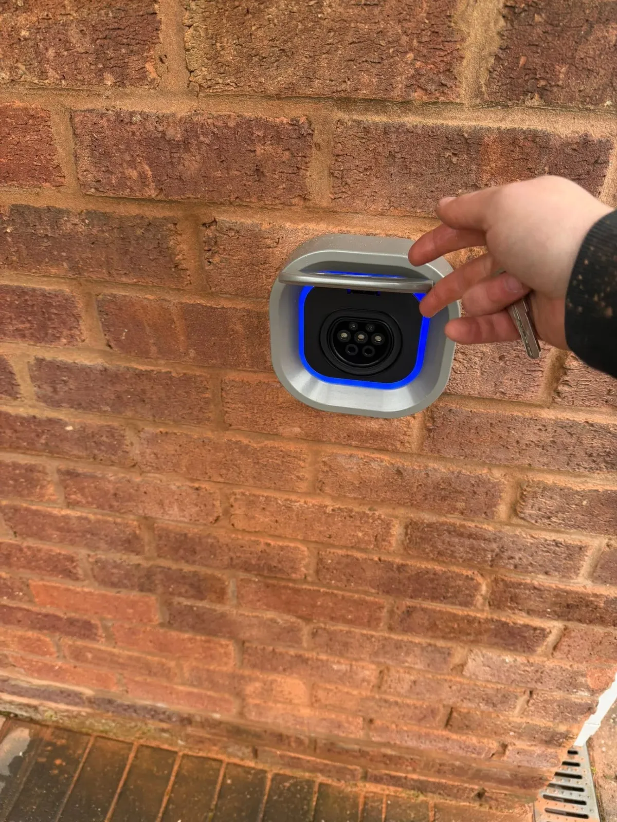 Close up of an installed EV charging point with illuminated socket on a domestic property