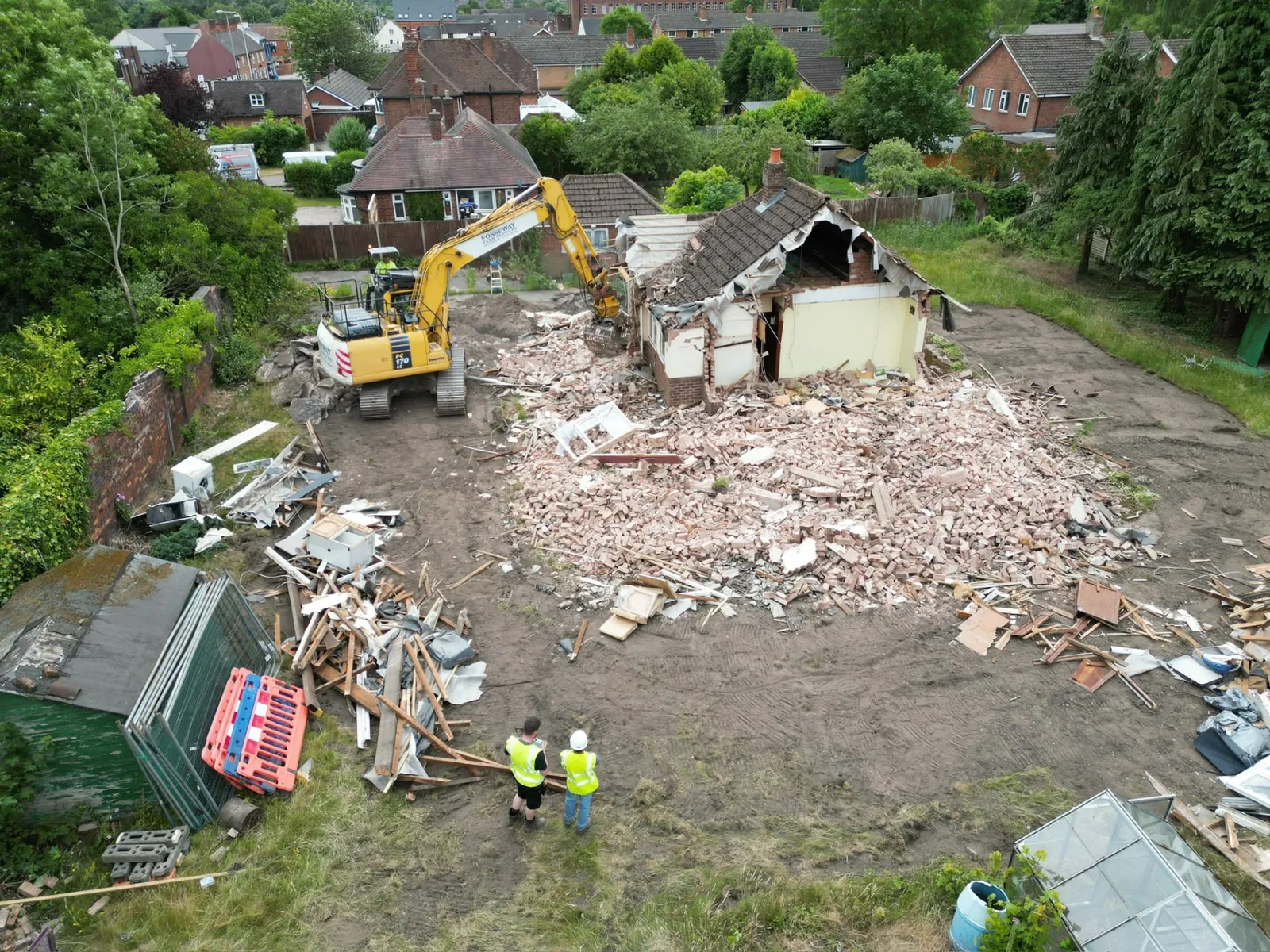 Excavator demolishing a property and clearing the site ready for new foundations