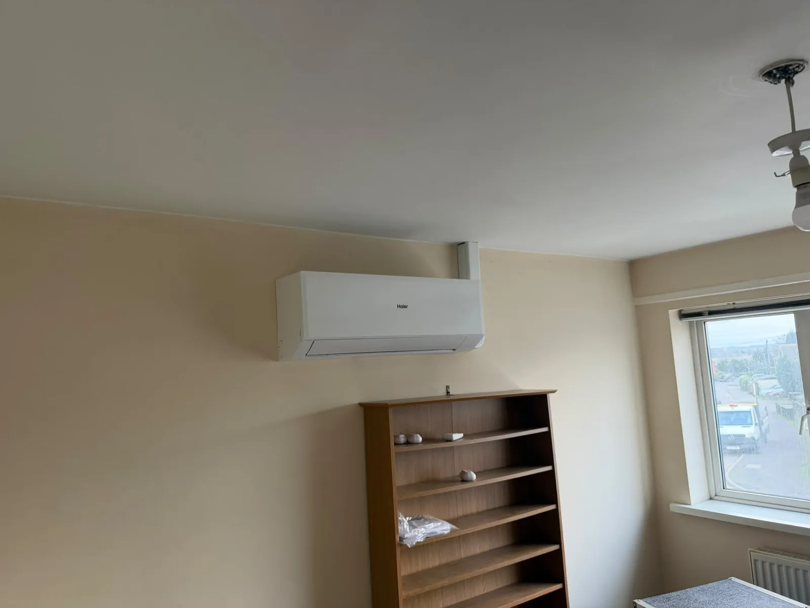 Split system air conditioning indoor unit fitted above a doorway after installation
