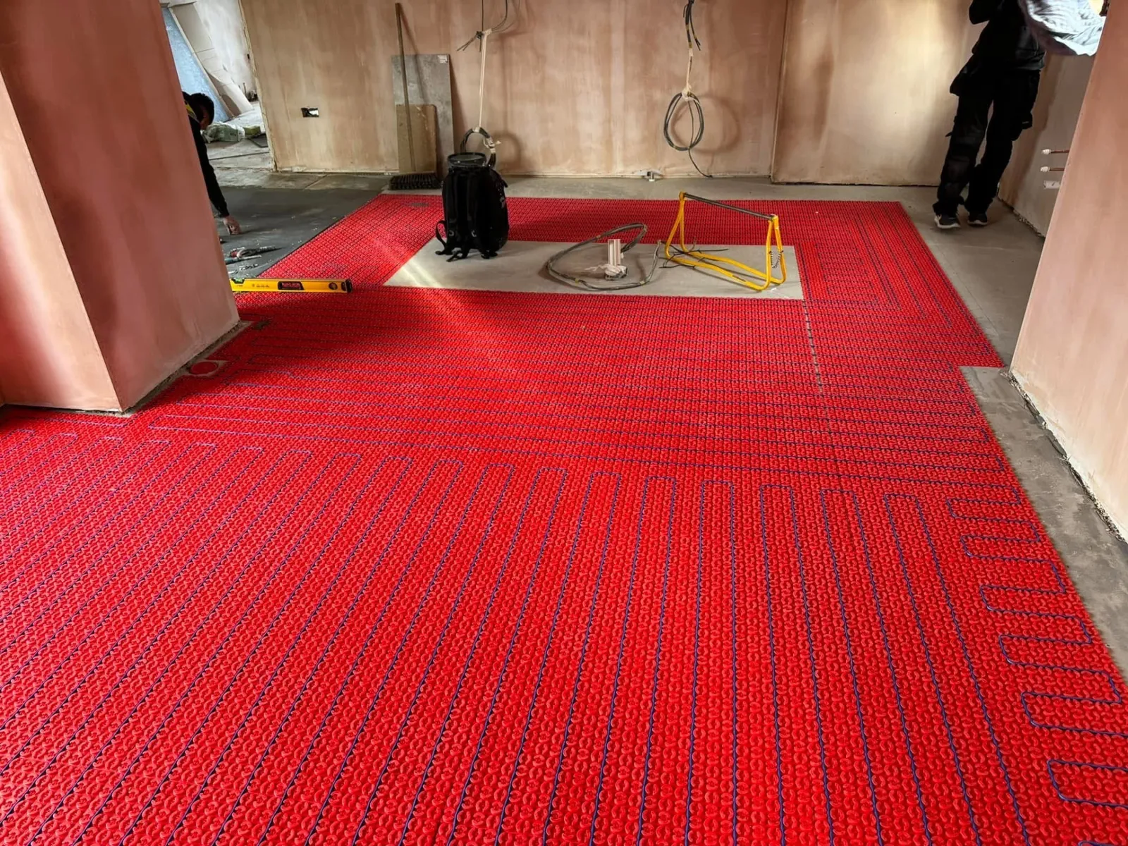 Electric underfloor heating mat installed across a floor before screeding and connection